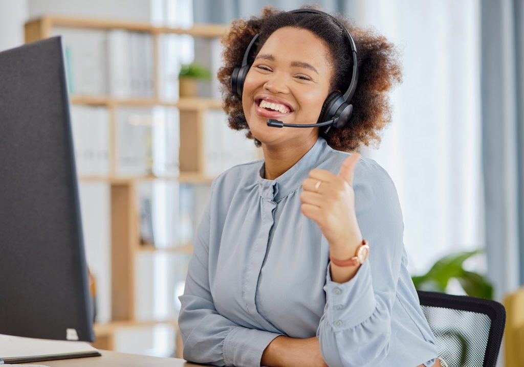 Happy professional transcriber giving a thumbs up while making human transcriptions