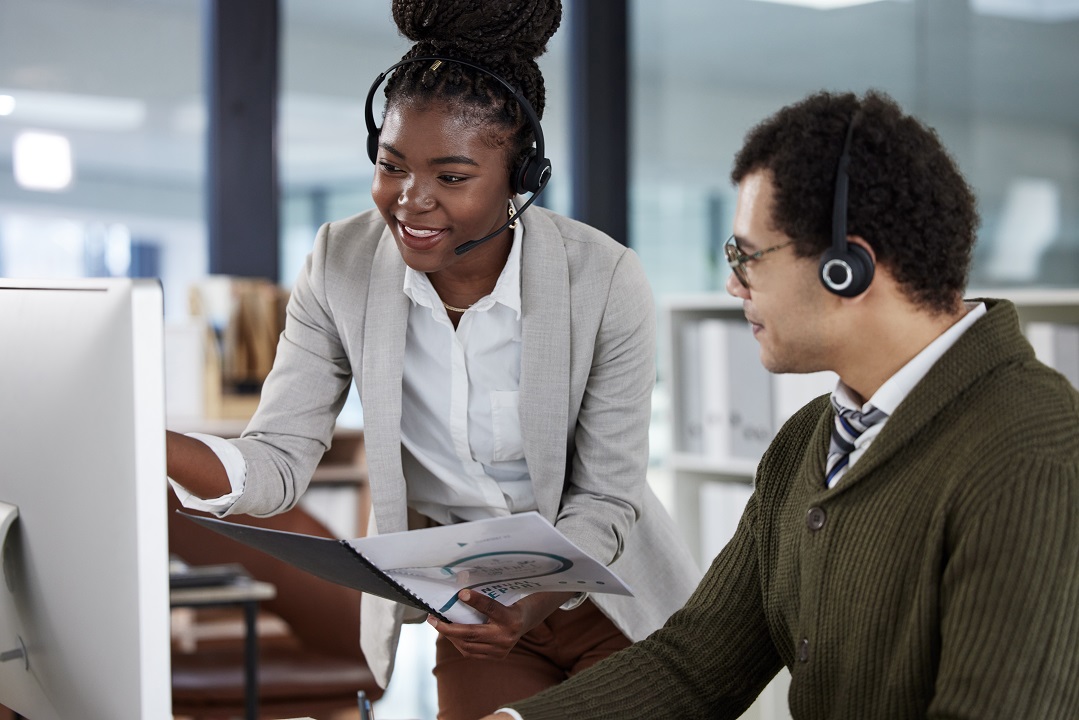 Two colleagues in the same company using business transcription to create simplified business reports